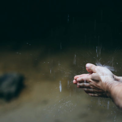 This is a photo of a pair of hands washing under falling rain used for the article titled 'The cost of business integrity is priceless' written by Phoebe Netto, PR Consultant from Sydney.