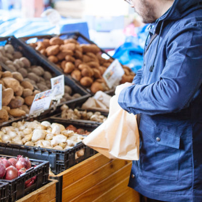 By giving your customers too many options and choice, you may be losing sales. Photo of man choosing fresh produce options, used in blog post by Good Business Consulting about how small businesses can create the right options that lead to purchases.