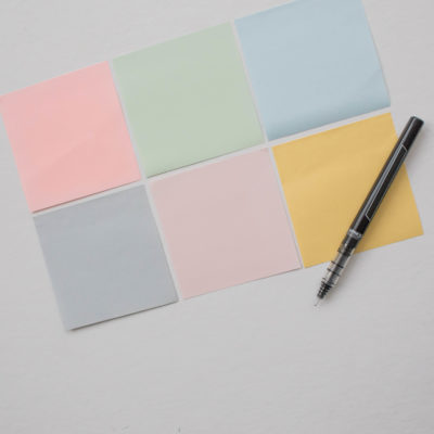Post-it notes and pen used to brainstorm types of media outlets to include on a PR media list. This article from Good Business Consulting gives you guidelines for identifying which media to target.